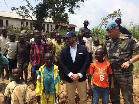 The Legal Counsel alongside of DFC MG Baillaud with Congolese children in Pinga.