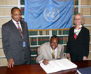 8 February 2008.Signing of the Convention on the Rights of Persons with Disabilities, United Nations Headquarters, New York. Mr. Jean-Marie Ehouzou, Permanent Representative of the Republic of Benin (center), signing the Convention. To the right Ms. Annebeth Rosenboom, Chief of the Treaty Section, United Nations Office of Legal Affairs.