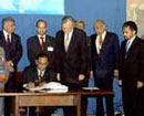 23 September 2003, Signing of the Convention on the Safety of United Nations and Associated Personnel, United Nations Headquarters, New York: Mr. Tyronne Fernando, Minister for Foreign Affairs of the Democratic Socialist Republic of Sri Lanka (seated), signing the Convention; Mr. Hans Corell (fourth from right), Under-Secretary-General for Legal Affairs and Legal Counsel; and Mr. Palitha T.B. Kohona (far right), Chief of the Treaty Section.