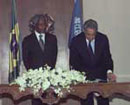 13 July 1998, Signing of the Comprehensive Nuclear-Test Ban Treaty, Brasilia, Brazil: Mr. Fernando Henrique Cardoso, President of Brazil, signing the Treaty; to his left, Secretary-General Kofi Annan.