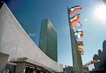 A view of the Headquarters of the United Nations in New York as seen from the north of the UN site. The buildings are the General Assembly (left) and the 39-storey Secretariat. The flags of 148 UN Member States fly in a row over 500 feet long overlooking the United Nations Plaza