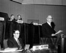 1 March 1958, United Nations Conference on the Law of the Sea, meeting of the First Committee, Geneva, Switzerland: George A. Drew, Head of the Canadian Delegation, addressing the Committee (at right, in the foreground); Mr. Sergio Gutierrez Olivos (Chile), Vice-Chairman of the First Committee (at left, in the foreground); Mr. K.H. Bailey (Australia), Chairman of the First Committee (at left, in the background); Mr. W. W.Cox, Secretary of the Committee (at right, in the background). 