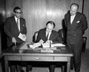 31 October 1958, Signature of the four international conventions adopted by the United Nations Conference on the Law of the Sea, Office of the Legal Counsel, United Nations Headquarters, New York: Prince Aly Khan, Pakistan's Permanent Representative to the United Nations, signing the instruments on behalf of his Government; Mr. U. Rahman Khan (left), member of the delegation of Pakistan; and Mr. Conetantin A. Stavropoulos (right), United Nations Legal Counsel. 