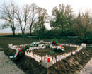 1 November 1996, Ovcara, Croatia: candles and wreaths marking the mass grave site. 