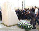 17 November 2002, United Nations House, Sarajevo, Bosnia and Herzegovina: Secretary-General Kofi Annan (right) placing a wreath at a monument to UN personnel who lost their lives in the former Yugoslavia. 