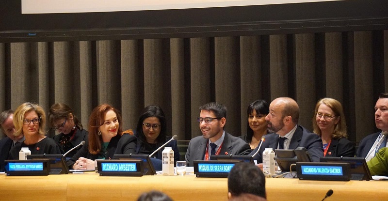 The Legal Counsel, Mr. Serpa Soares, on the podium with the President of the General Assembly, Ms. María Fernanda Espinosa, and other panelists